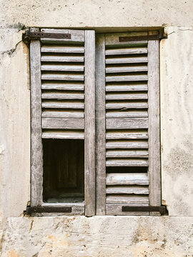 An old broken wooden window shutter