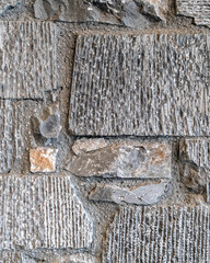 grey and brown stone wall closeup, rough pattern background