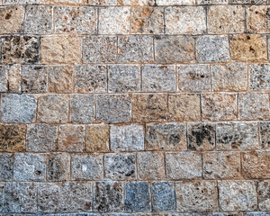 regular cut stone wall closeup, natural textured background