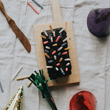 Chocolate Birthday Cake, Candles, Party Hat, and Party Noisemaker