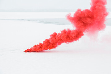 red smoke on the white snow