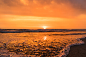 Sun rising behind the horizon at a beach