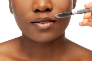 beauty, plastic surgery and people concept - close up of face of beautiful young african american...