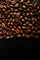 Coffee beans on wooden background.