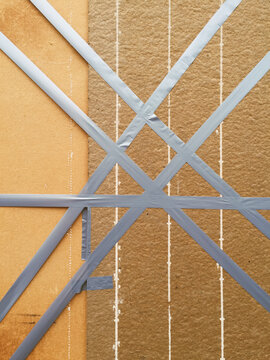 Duct tape across wood panel, covering broken shop window