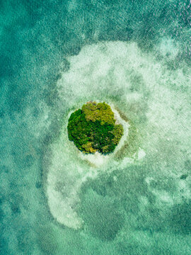 Overhead drone shot of a tiny island in the Atlantic Ocean