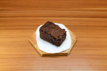 Fototapeta na wymiar Chocolate brownie cake slices served on a wood with a wooden background. 