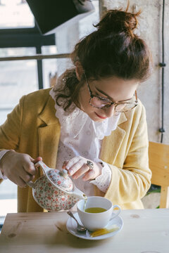 Woman Pouring Green Tea at the Cafe