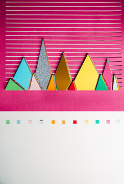 Colorful 3D graphs cut out of paper on striped background