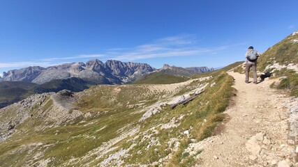 Fototapeta premium Val Gardena, Italy - 09/15/2020: Scenic alpine place with magical Dolomites mountains in background, amazing clouds and blue sky in Trentino Alto Adige region, Italy, Europe