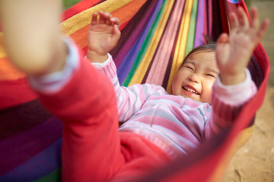 happy little asian girl slepping in the hammock