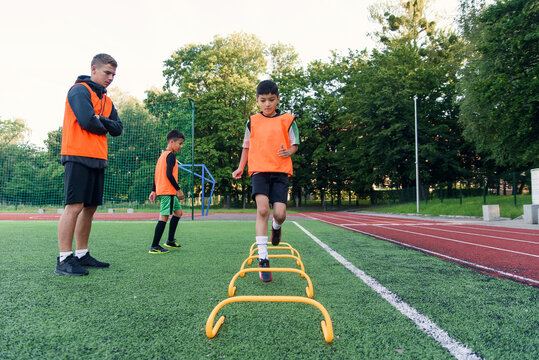 Children's football players during team training before an important match. Exercises for the youth football team.