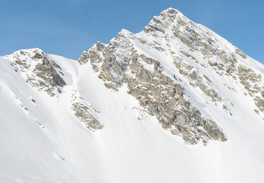 Snowboarder sliding down the mountain slope