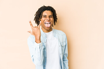 Young african american rasta man showing rock gesture with fingers
