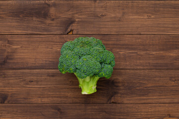 Fresh green broccoli over brown wooden background