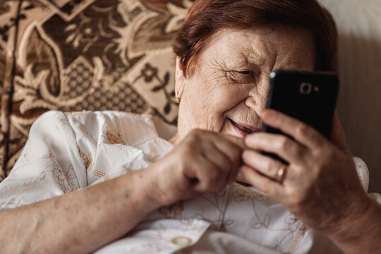 Old woman using mobile phone