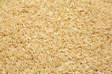Dry Brown Rice background, top view. Overhead, from above, flat lay.