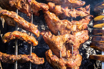 Grilled pork ribs on the grill with metal skewers