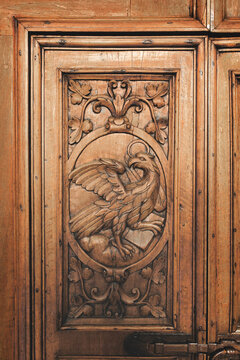 Eagle inlaid on ancient abbey's wooden portal symbolizing John evangelist