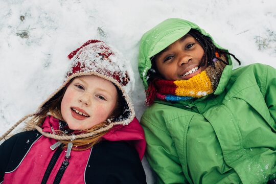 Caucasian and black girls in the snow