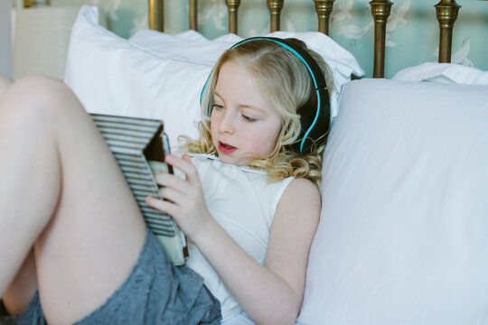 A little girl listening to music