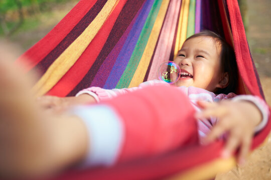 happy little asian girl slepping in the hammock
