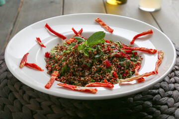 Red quinoa salad with dry tomato slices