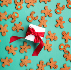 Gingerbread cookies and gift, blue mint background