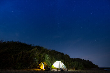 Fototapeta na wymiar Night landscape with tents and stars on the sky 