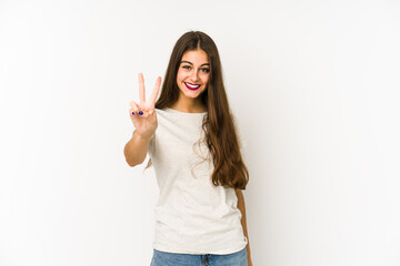 Young caucasian woman isolated on white background showing number two with fingers.