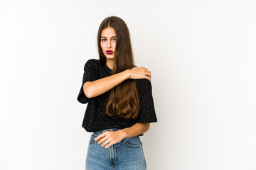 Young caucasian woman isolated on white background having a shoulder pain.