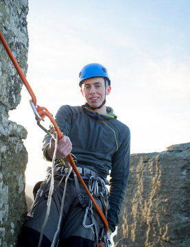 Teenage boy, rock climbing.