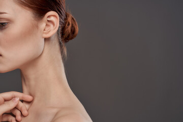 Beautiful woman naked shoulders cosmetics clean skin charm gray background studio