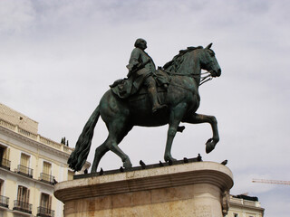 Fototapeta na wymiar Madrid, Spain, August 15, 2015: Monument to King Carlos III in Puerta del Sol square. Madrid