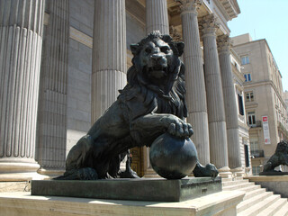 Madrid, Spain, August 19, 2015: Cast iron lion on the entrance stairs to the Congress of Deputies....