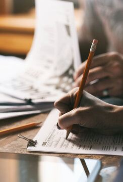 Taxes: Focus On Woman Writing Information On Tax Form