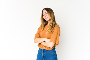 Young caucasian woman isolated on white background who feels confident, crossing arms with determination.