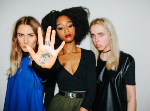 Three beautiful women with one showing her broken handcuff tattoo