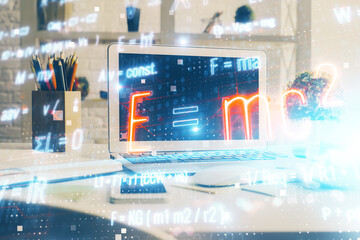 Desktop computer background and formula hologram writing. Double exposure. Education concept.