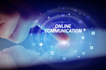Finger touching tablet with social media icons and ONLINE COMMUNICATION