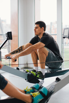 Man training on ergometer indoor