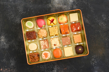 Indian sweets, Diwali sweets mithai milk Peda and Halwa or Halva, flavored variety of assorted dessert in box to gift on Deepavali, Pongal, Durga Pooja, Holi, Diwali festival in India.