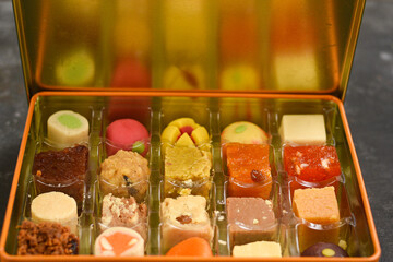 Indian sweets, Diwali sweets mithai milk Peda and Halwa or Halva, flavored variety of assorted dessert in box to gift on Deepavali, Pongal, Durga Pooja, Holi, Diwali festival in India.