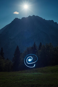 Light painting against mountain landscape