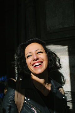 Beautiful Iranian woman laughs happily.