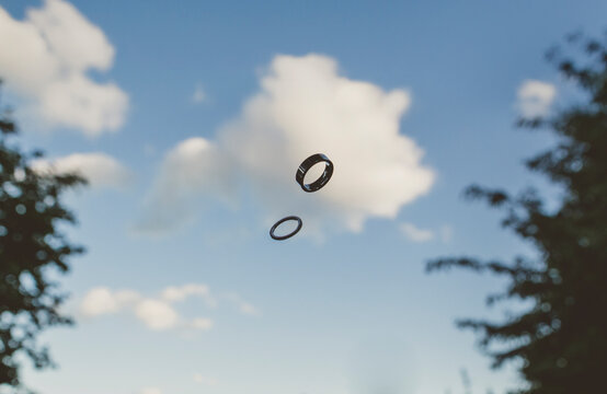 Wedding rings on sky and cloud background