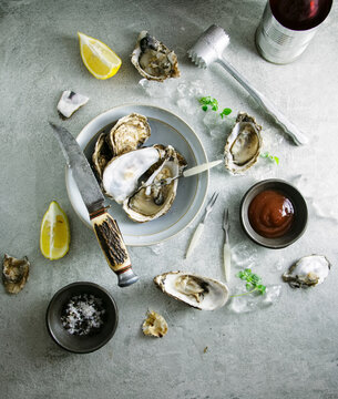 Oysters and condiments on a table. Seen from overhead.