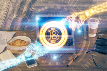 Double exposure of blockchain theme hologram and table with computer background. Concept of bitcoin crypto currency.