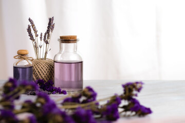 Obraz na płótnie Canvas Lavender oil aroma therapy for body and mind relaxation on white marble table with white dried flower decoration.