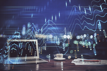 Stock market chart hologram drawn on personal computer background. Double exposure. Concept of investment.